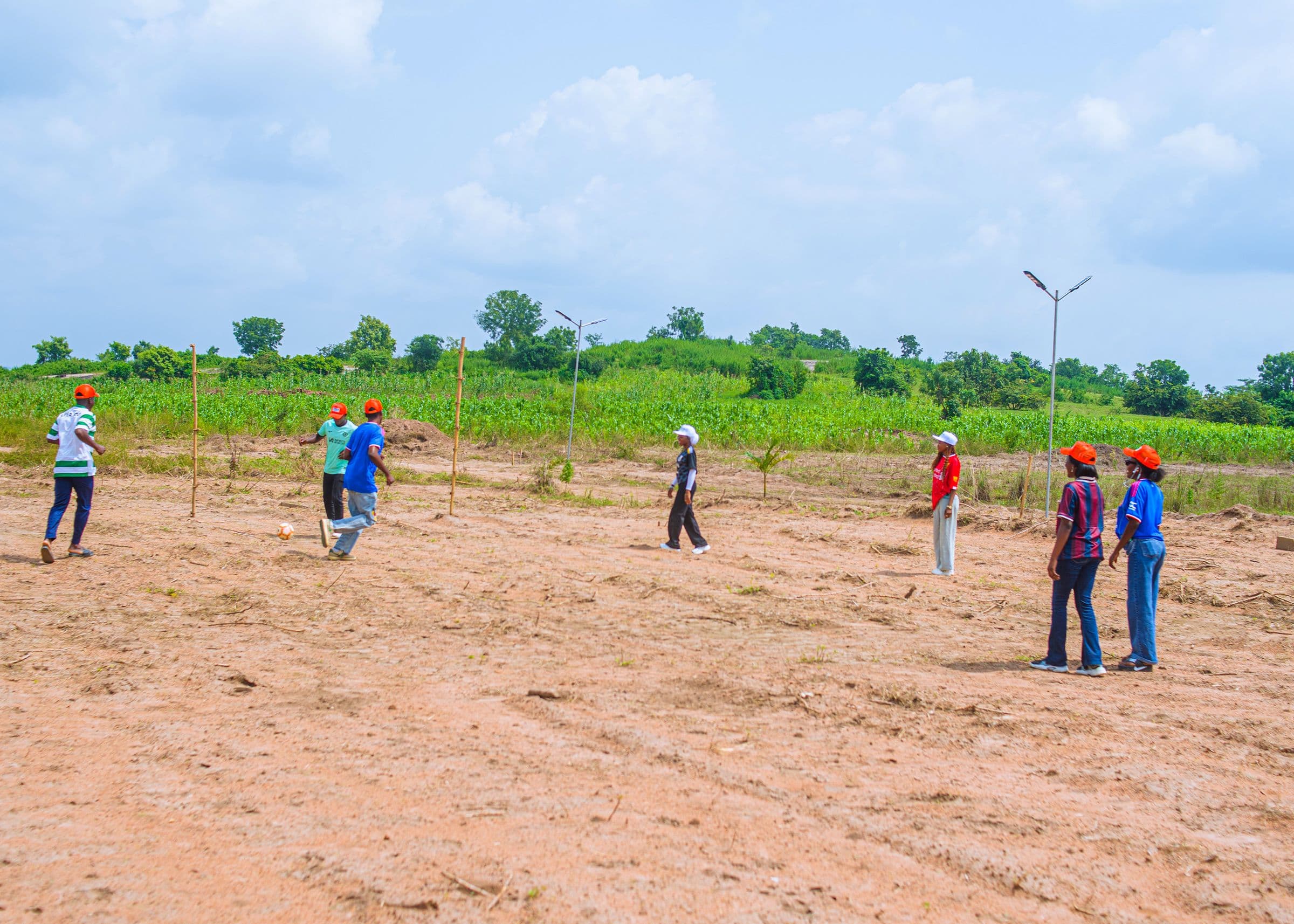 The Pace team out on open land in Oyo, with boundary poles marking the plots